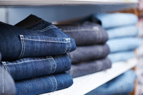 Photo: jeans clothes on shelf in shop jeans clothes on shelf in shop