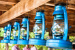 Perspective view of storm lanterns hanged on wooden counterpoise
