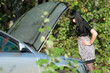 The girl looks at a car engine
