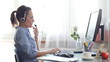 Attractive helpdesk consultant talking on headset
