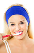 Young happy woman brushing teeth