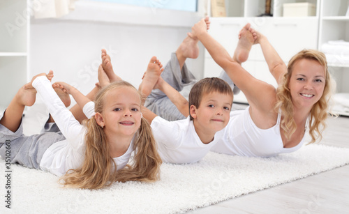 Photo: Family doing stretching exercises at home Family doing stretching exercises at home