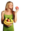 woman holds a pile of fruit