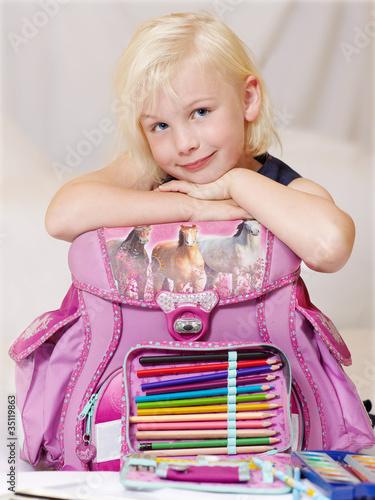 Foto: Cute blond child is happy to start at school Cute blond child is happy to start at school