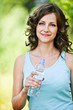 Young brunette woman holding bottle of water