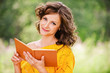 Portrait of beautiful woman holding book