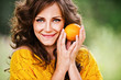 pretty woman holding orange