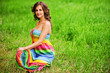 Young beautiful woman sitting on grass