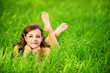 young woman lying on grass