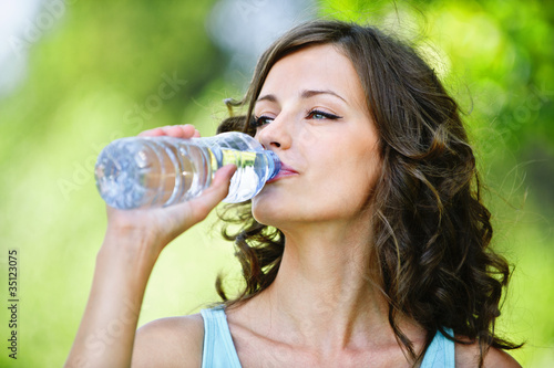 Photo: young dark-haired woman drinking water young dark-haired woman drinking water