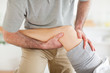 Chiropractor massaging a woman's knee