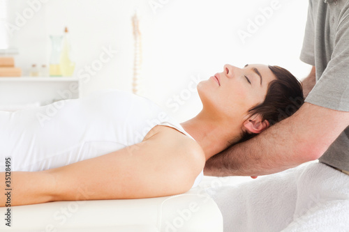 Photo: Woman relaxing during a massage Woman relaxing during a massage