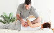 Masseur massaging woman