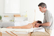 Masseur stretching woman's head
