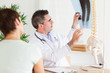 Male Doctor showing a female patient a x-ray