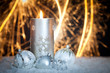 christmas background with candle, christmas balls and sparklers