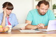 Video: Worried couple calculating their bills by the table Worried couple calculating their bills by the table