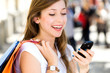 Girl with mobile phone and shopping bags