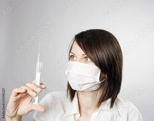 Photo: Nurse in mask with syringe Nurse in mask with syringe