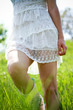 Girl in white dress walking in the green field Girl in white dress walking in the green field