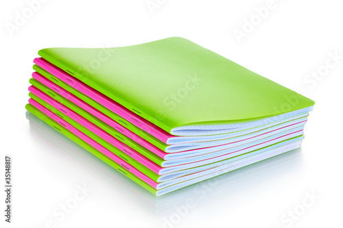 Photo: Green and pink notebooks isolated on white Green and pink notebooks isolated on white