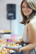 womanl chooses tasty meal in buffet at hotel