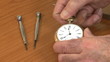 Watchmaker examines pocket watch