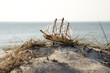 Miniature ship standing on sand