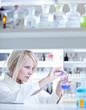 Photo: Closeup of a female researcher carrying out experiments in lab Closeup of a female researcher carrying out experiments in lab