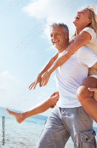 Photo: Cheerful couple piggybacking Cheerful couple piggybacking