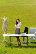 Businesswoman in sunny meadow nature office smile