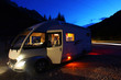 Camper van parked at night next to the road