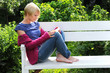 woman reading book in park