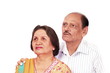Photo: Senior indian couple looking up with worry expression Senior indian couple looking up with worry expression