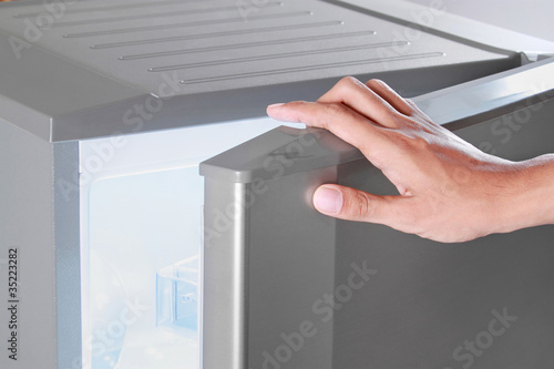 Photo: hand opening refrigerator hand opening refrigerator