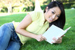 Young woman reading book in park
