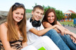 small group of students sitting on street