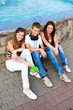 small group of students sitting on street