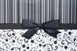 Black gift bow on black seamless pattern