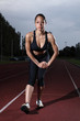 Hamstring stretch female athlete on running track