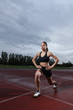 Lunge exercise for quadriceps by athlete on track