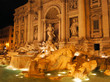 Trevi Fountain of Rome under the glow of evening lights