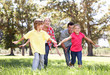 Parents playing with children in country
