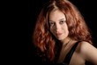 Woman portrait in evening dress on black