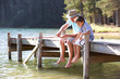 Senior man fishing with grandson