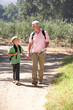 Senior man and grandson on country walk Senior man and grandson on country walk