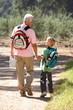 Senior man and grandson on country walk