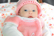 Macro portrait of baby in pink hat and dress with blue eyes Macro portrait of baby in pink hat and dress with blue eyes