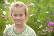 Portrait of a beautiful girl on the background of flowers
