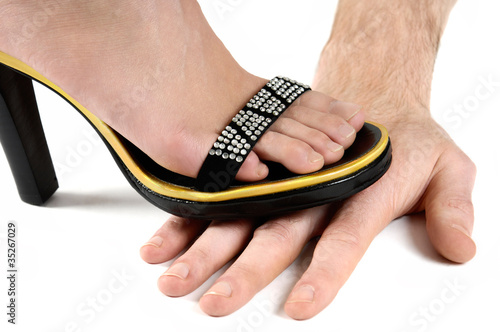 Photo: Woman Standing on Man's Hand Woman Standing on Man's Hand